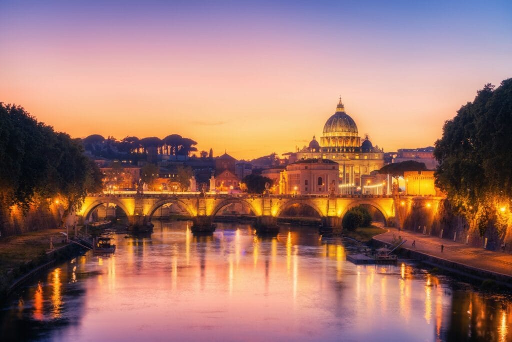 Sunset Over St. Peter’s Basilica and Ponte Sant'Angelo – Rome Evening Reflections St. Peter’s Basilica and Ponte Sant'Angelo illuminated at sunset in Rome, Italy, with colorful reflections on the Tiber River