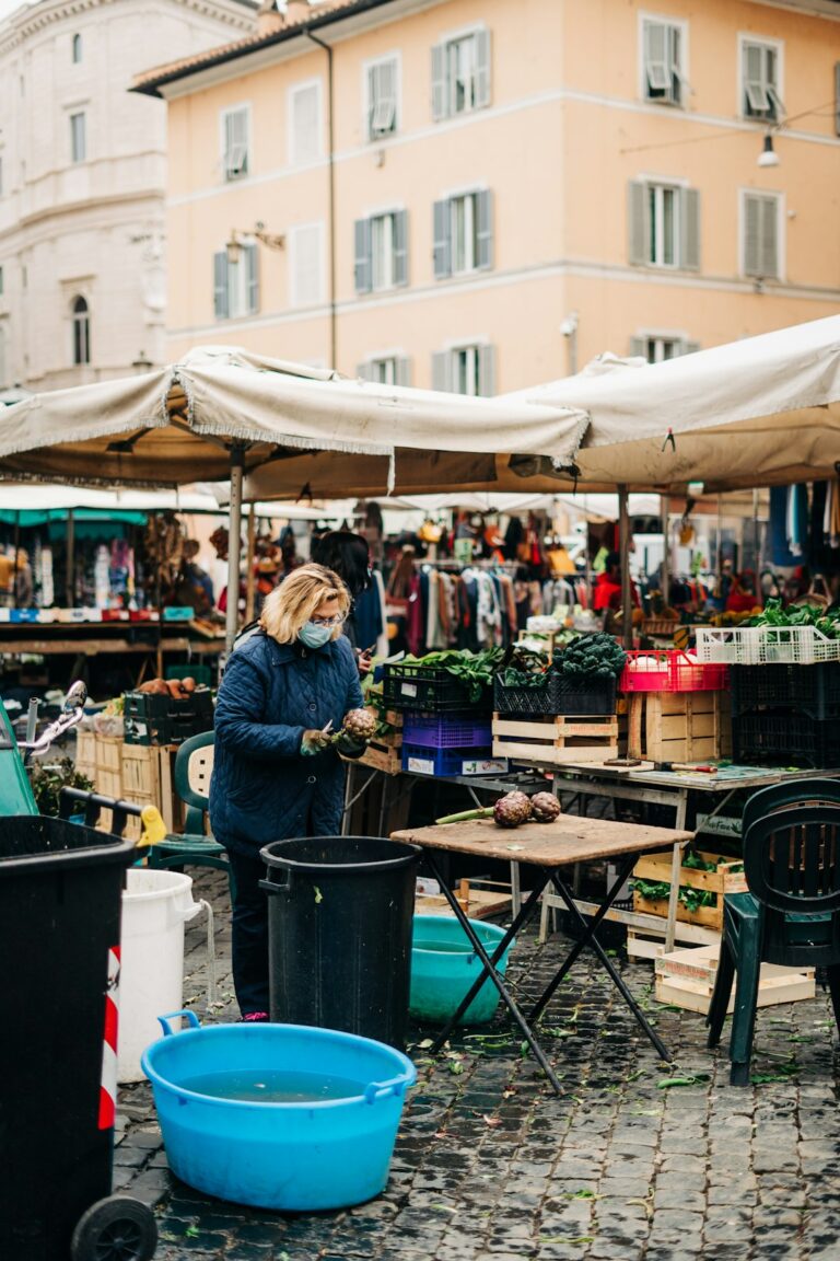 Stall owner cleaning artichokes in Rome's traditional Campo de' Fiori outdoor market during the Covid-19 pandemic