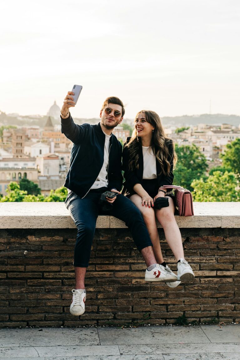 Young couple taking a selfie during golden hour in the Giardino degli Aranci in Rome, Italy