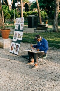 Street artist painting scenes of Rome, Italy
