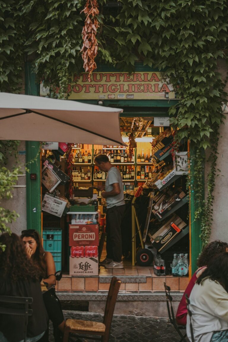a group of people sitting at a table in front of a store
