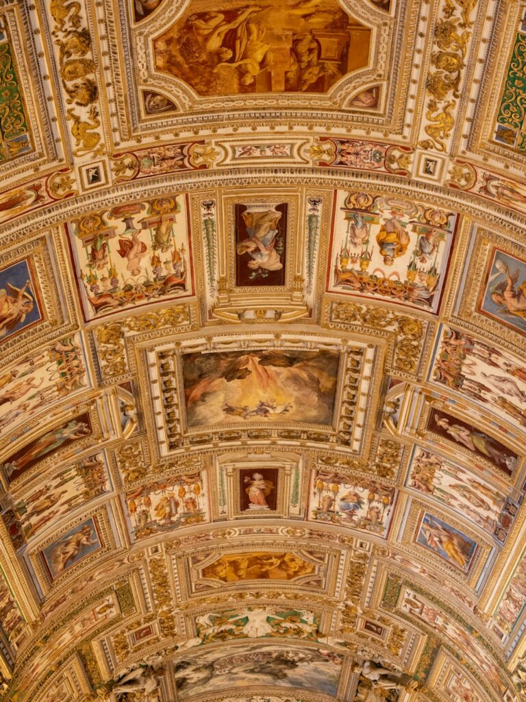 the ceiling of a building with paintings on it
