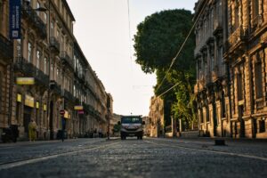 a street with buildings and a van
