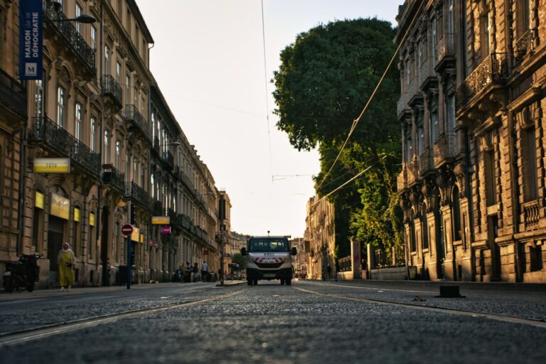 a street with buildings and a van