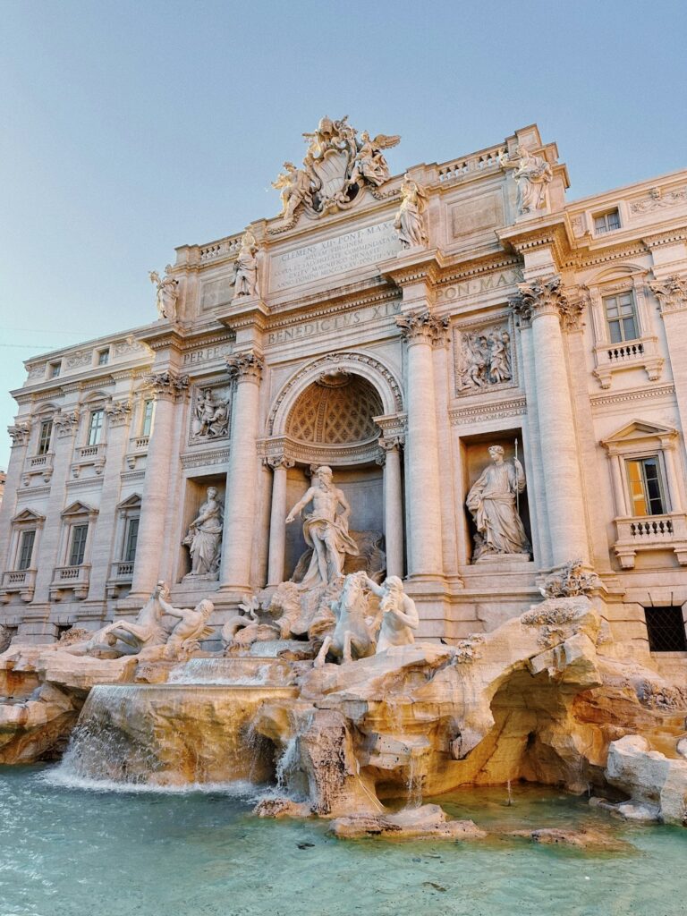 a large building with a fountain in front of it