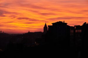 a sunset view of a city with buildings in the foreground