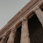 a tall stone building with two large pillars