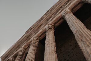 a tall stone building with two large pillars