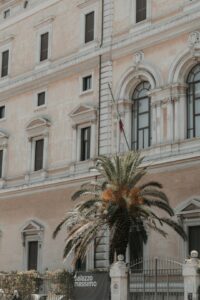a large building with a palm tree in front of it