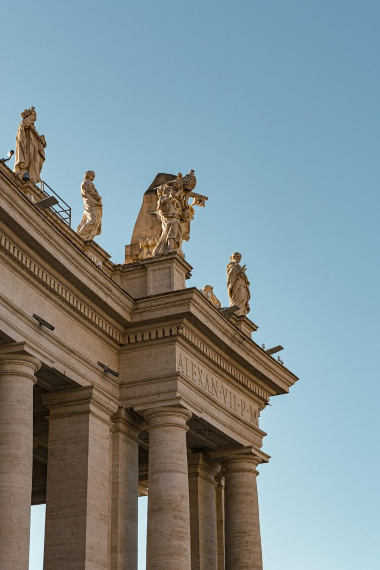 a tall building with statues on top of it