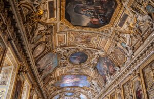 the ceiling of a building with paintings on it