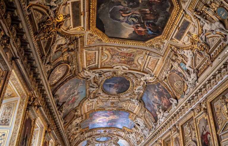 the ceiling of a building with paintings on it