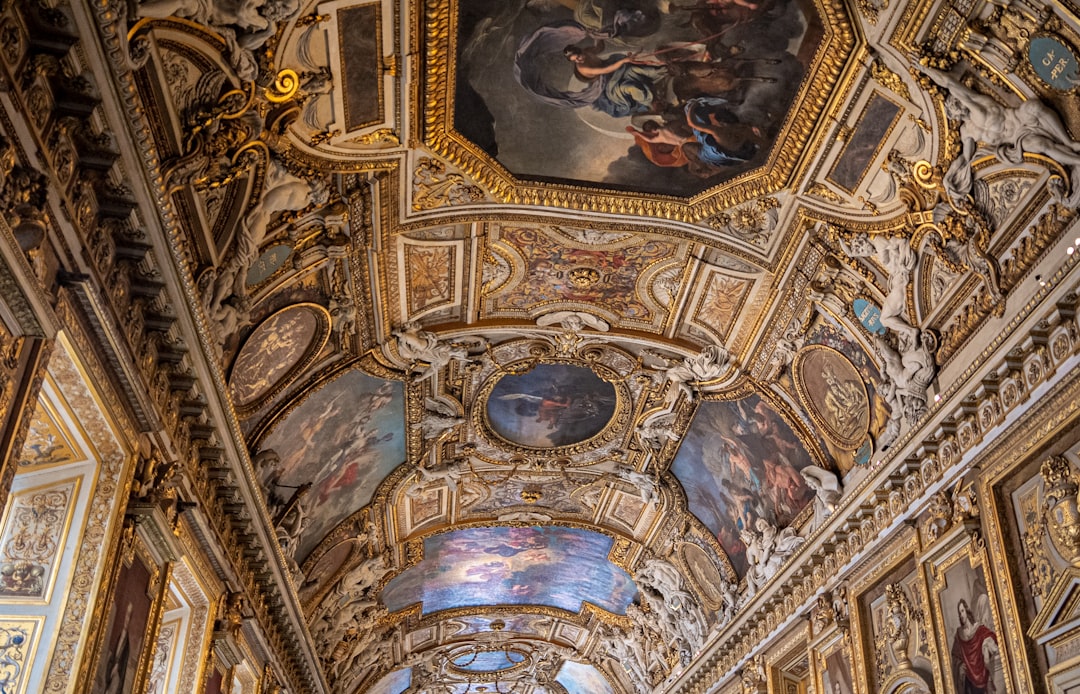 the ceiling of a building with paintings on it