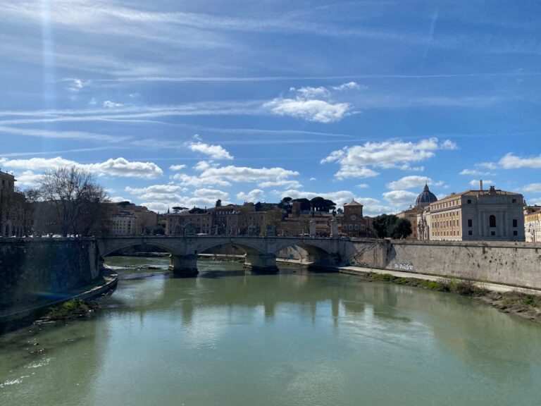 a river running through a city next to a bridge