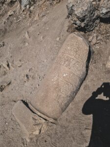 a shadow of a person taking a picture of a grave