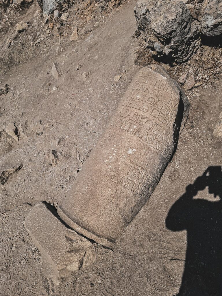 a shadow of a person taking a picture of a grave