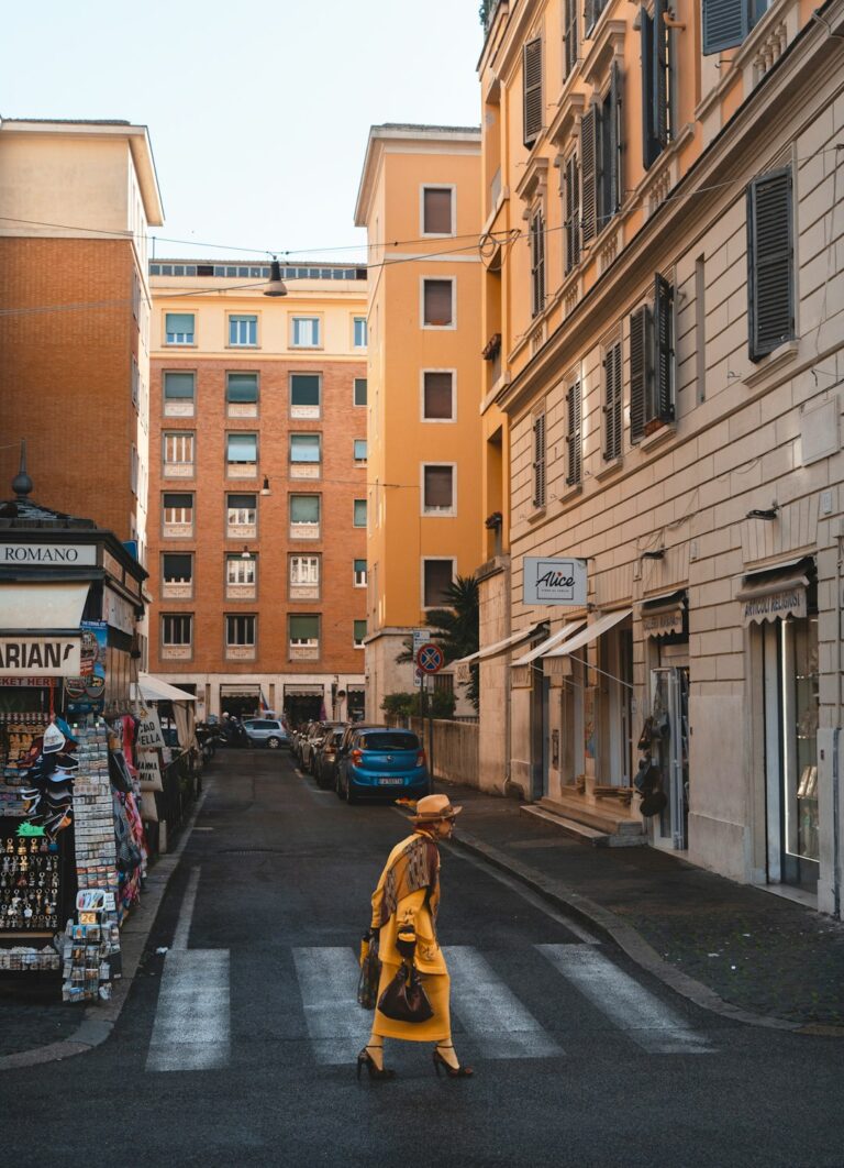 a woman crossing a street in a city