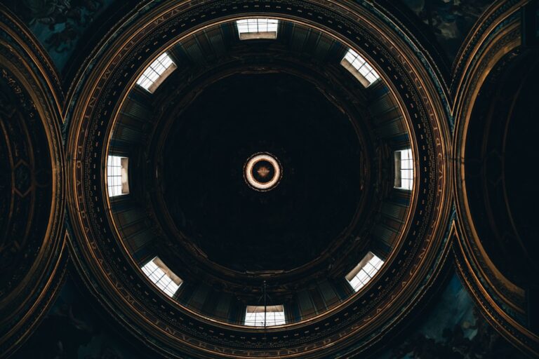 the ceiling of a building with a circular window