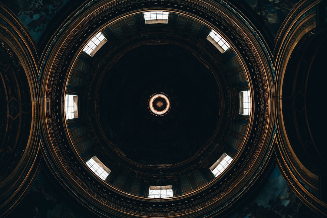 the ceiling of a building with a circular window