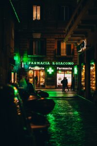 a person walking down a street at night