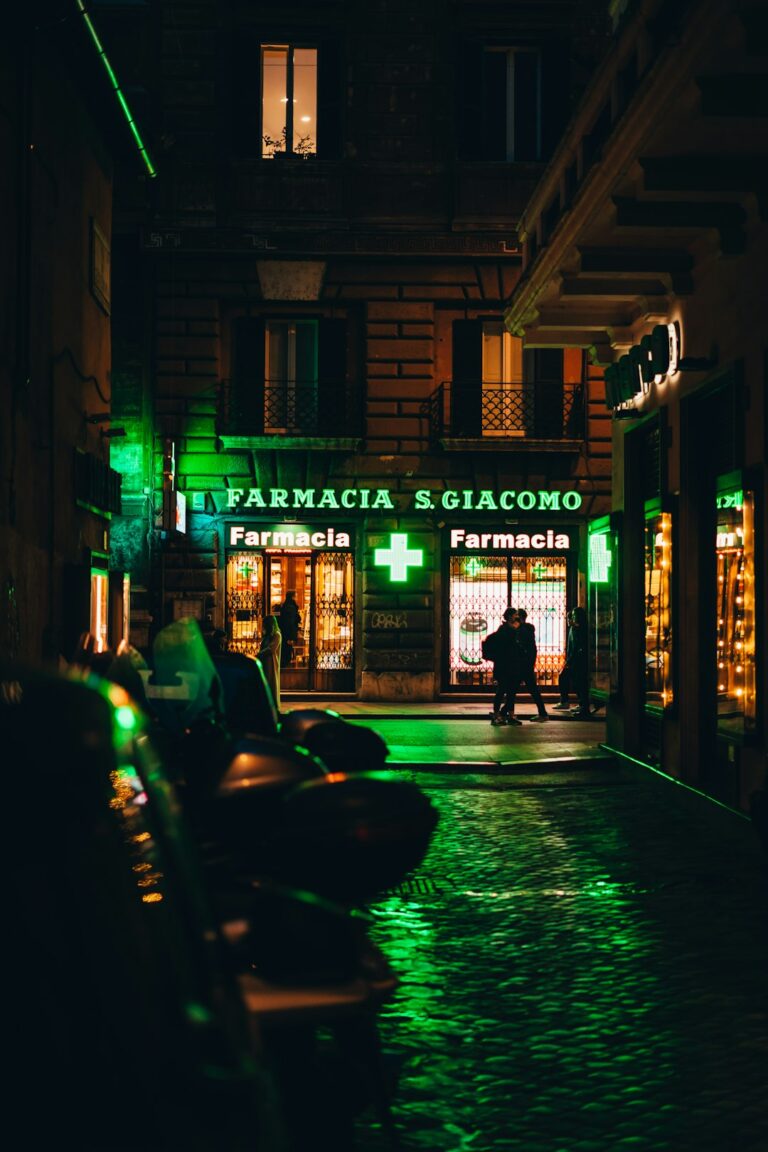 a person walking down a street at night