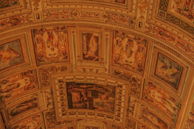 the ceiling of a building with paintings on it