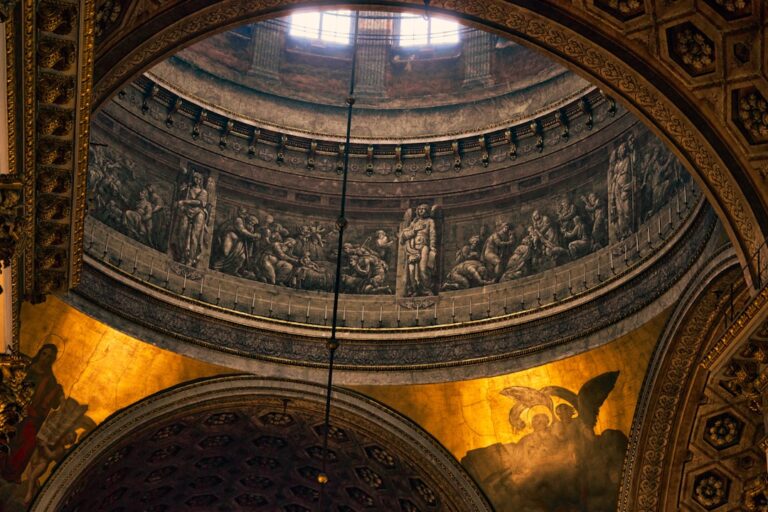 An ornate church ceiling with paintings.