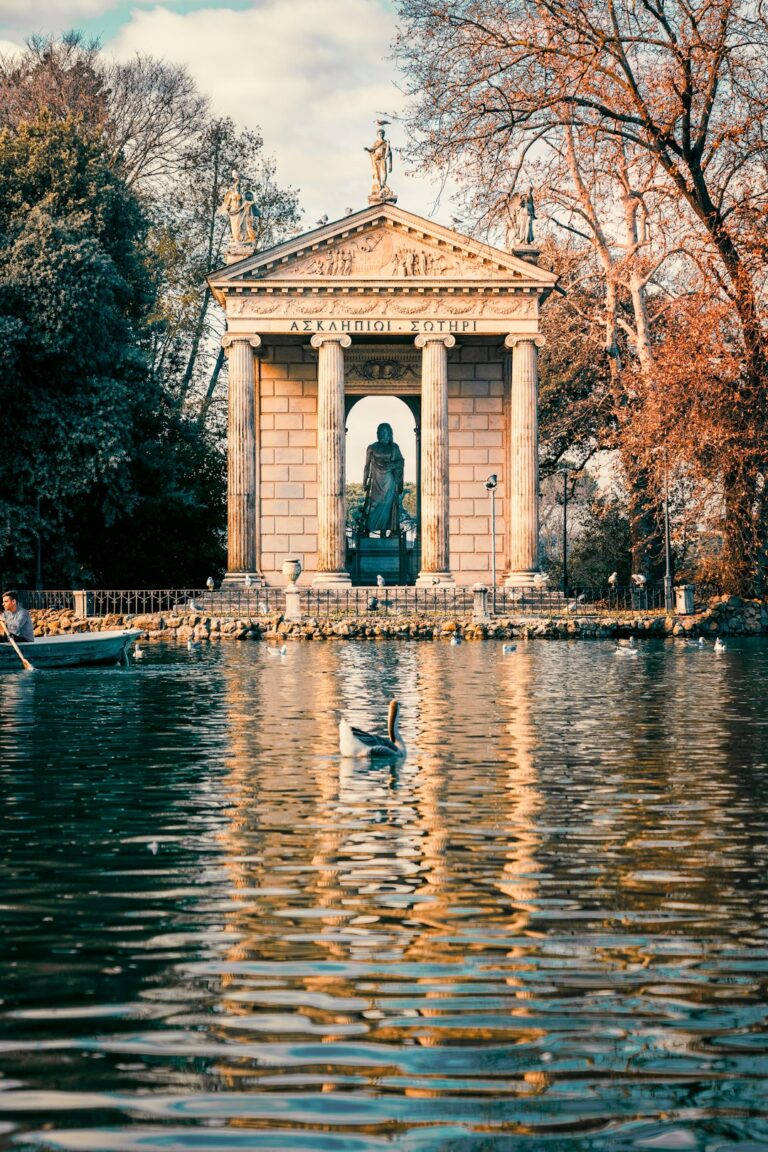 Classical temple is reflected in a serene lake.