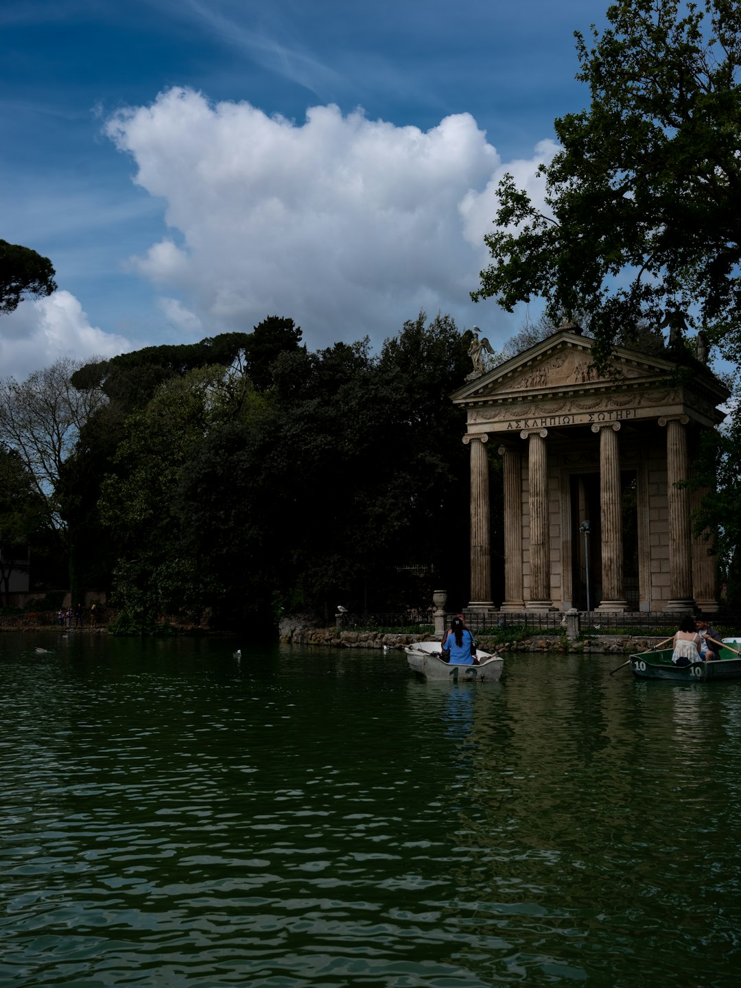 Visitors enjoy rowing boats on the tranquil waters surrounding the Temple of Asclepius in Rome’s lush Villa Borghese...