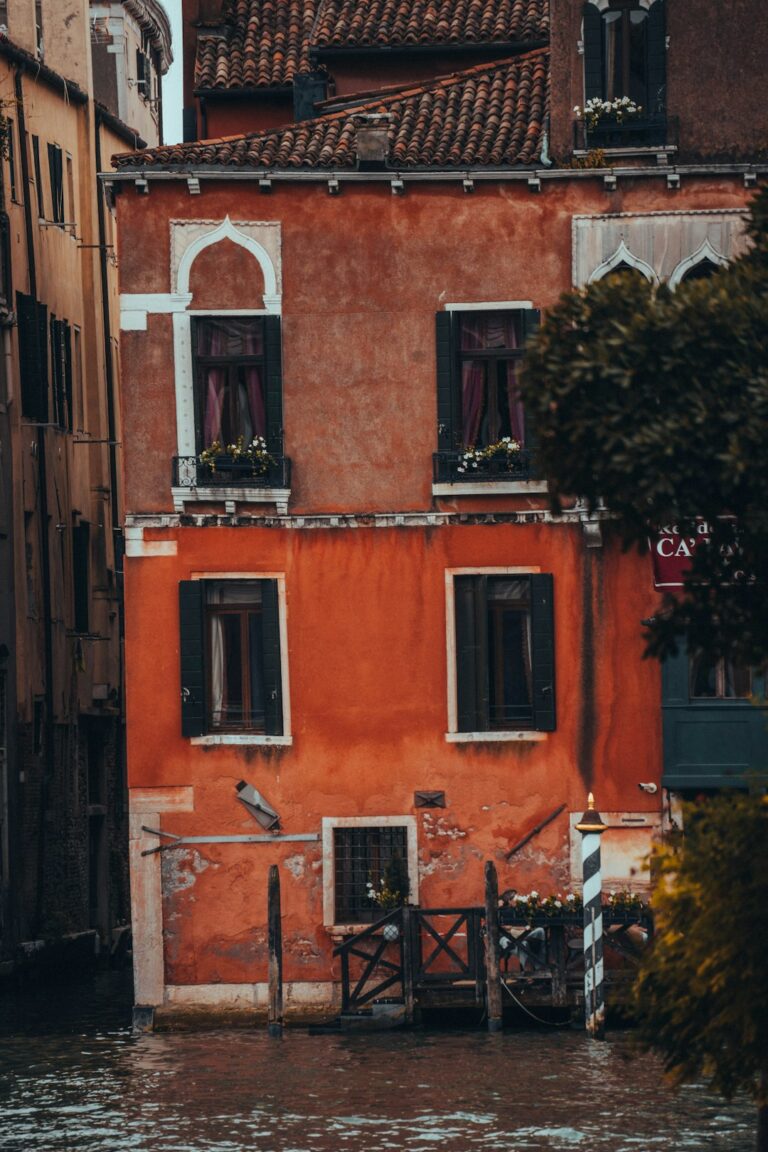 A colorful building sits on the water.