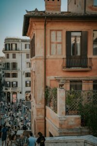 People ascend ornate steps in a historic european city.