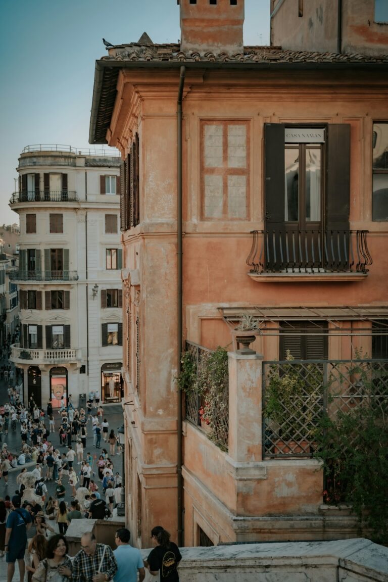 People ascend ornate steps in a historic european city.